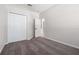Bedroom with carpeted floors features a walk-in closet, a white door, and neutral paint at 11611 Jordans Landing Ct, Riverview, FL 33569