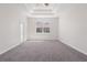 Bedroom with tray ceiling, large window, and door to the outside at 11611 Jordans Landing Ct, Riverview, FL 33569
