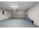 Spacious two-car garage featuring a clean, epoxy floor and an automatic door opener at 11611 Jordans Landing Ct, Riverview, FL 33569