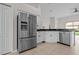 Open concept kitchen with stainless steel refrigerator and modern finishes at 11611 Jordans Landing Ct, Riverview, FL 33569
