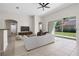 Staged living room featuring tile flooring, neutral walls, and sliding glass doors to the backyard at 11611 Jordans Landing Ct, Riverview, FL 33569