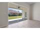 A bright sunroom with tile floors offers sliding door access to the backyard and covered patio at 11611 Jordans Landing Ct, Riverview, FL 33569