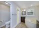 Bright bathroom featuring a soaking tub, glass-enclosed shower, and wood-look tile flooring at 1175 San Carlos Ne Ave, St Petersburg, FL 33702