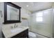 Updated bathroom with a vanity, marble-look countertop, and glass-enclosed shower at 1175 San Carlos Ne Ave, St Petersburg, FL 33702