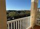 Balcony view with white railings and neighborhood trees and rooftops in the background at 1216 S Missouri Ave # 321, Clearwater, FL 33756