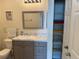 Bathroom vanity featuring marble countertop, decorative mirror and organized towels in built-in cabinet at 1216 S Missouri Ave # 321, Clearwater, FL 33756