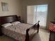 Bright bedroom with a queen size bed, large windows, and a view of the surrounding landscape at 1216 S Missouri Ave # 321, Clearwater, FL 33756