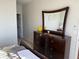 Bedroom featuring a dark wood dresser with mirror and plenty of natural light at 1216 S Missouri Ave # 321, Clearwater, FL 33756