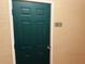Green entrance door with a 321S sign, complemented by textured hallway walls at 1216 S Missouri Ave # 321, Clearwater, FL 33756