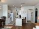 Open-concept kitchen with white appliances, a breakfast bar, and a view into the living area at 1216 S Missouri Ave # 321, Clearwater, FL 33756
