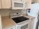 Well-equipped kitchen featuring white appliances and ample counter space at 1216 S Missouri Ave # 321, Clearwater, FL 33756
