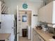 Functional kitchen with white cabinets, stainless steel refrigerator, and pantry access at 1216 S Missouri Ave # 321, Clearwater, FL 33756