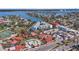 Nice aerial view of condos with a pool, tennis court, and access to beach and intercoastal waterways at 125 Shoals Cir, North Redington Beach, FL 33708