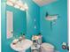 Coastal themed powder room featuring turquoise walls, beach-inspired decorations, and a pedestal sink at 125 Shoals Cir, North Redington Beach, FL 33708