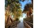 Private beach access with a wooden boardwalk leading to the beach surrounded by lush tropical foliage at 125 Shoals Cir, North Redington Beach, FL 33708