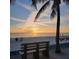 Serene beach view at sunset with a bench for relaxing and watching the waves at 125 Shoals Cir, North Redington Beach, FL 33708