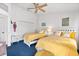 Bright and airy bedroom featuring two beds, a ceiling fan, and charming decor at 125 Shoals Cir, North Redington Beach, FL 33708
