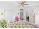 Bright bedroom with a ceiling fan, closet, and flamingo-themed bedding and decor at 125 Shoals Cir, North Redington Beach, FL 33708