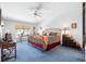 Spacious bedroom featuring a zebra-patterned bed, a ceiling fan, and a comfortable seating area at 125 Shoals Cir, North Redington Beach, FL 33708