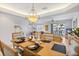 Open concept dining room featuring modern light fixture and dining table at 125 Shoals Cir, North Redington Beach, FL 33708