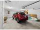 Spacious garage featuring ample storage space and parking for a red SUV at 125 Shoals Cir, North Redington Beach, FL 33708