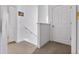 Bright hallway with neutral carpet, white walls, and doors leading to various rooms in the home at 125 Shoals Cir, North Redington Beach, FL 33708
