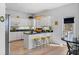 Bright kitchen with white cabinets, under cabinet lighting, breakfast bar, and a backyard view at 125 Shoals Cir, North Redington Beach, FL 33708