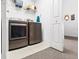 Efficient laundry room with modern washer and dryer units and ample storage at 125 Shoals Cir, North Redington Beach, FL 33708