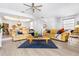 Inviting living room with modern furnishings, ceiling fan, and seamless transition to dining area at 125 Shoals Cir, North Redington Beach, FL 33708