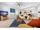 Comfortable living room with a ceiling fan, an entertainment center, and an adjacent dining area at 125 Shoals Cir, North Redington Beach, FL 33708