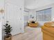 Bright living room featuring wood floors, large windows, and a comfortable yellow chair at 125 Shoals Cir, North Redington Beach, FL 33708