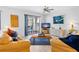 Bright living room featuring modern furniture, a ceiling fan, and a sliding glass door to the balcony at 125 Shoals Cir, North Redington Beach, FL 33708