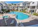 Beautiful community pool with lounge chairs, tables, and well-maintained landscaping at 125 Shoals Cir, North Redington Beach, FL 33708