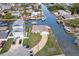 Waterfront home aerial view featuring canal access, boat dock and a paved driveway at 13437 Lisa Dr, Hudson, FL 34667