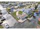 Aerial view of a light blue waterfront property, with dock, green lawns, & a paved driveway at 13437 Lisa Dr, Hudson, FL 34667