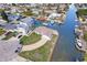 An aerial view of a waterfront home with boat dock, and paved driveway in a residential neighborhood at 13437 Lisa Dr, Hudson, FL 34667