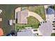 Aerial view of waterfront property showing paved driveway, dock, and canal access on a sunny day at 13437 Lisa Dr, Hudson, FL 34667