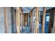 Unfinished living room space featuring block walls, framing and concrete floors ready for customization at 13437 Lisa Dr, Hudson, FL 34667