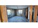 Unfinished bedroom showcasing natural light through two windows with block walls and concrete floors at 13437 Lisa Dr, Hudson, FL 34667