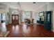 Open dining room features beautiful wood floors, a decorative chandelier, and a dining set at 1354 Forestedge Blvd, Oldsmar, FL 34677