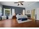 Comfortable main bedroom with hardwood floors, ceiling fan, and stylish decor at 1354 Forestedge Blvd, Oldsmar, FL 34677