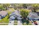 Aerial view of a home with a 3-car garage, mature trees and manicured landscaping at 13542 Norman Cir, Hudson, FL 34669