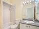 Clean bathroom featuring a shower-tub combo, sink and vanity, creating a functional space at 13542 Norman Cir, Hudson, FL 34669