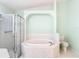 Bathroom with a large soaking tub, separate shower, and modern fixtures at 13542 Norman Cir, Hudson, FL 34669