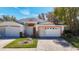 Charming single Gathering home with a well-manicured lawn and brick driveway, perfect for suburban living at 13542 Norman Cir, Hudson, FL 34669