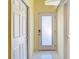 Bright hallway with tile flooring and doors, creating a clean and spacious feel at 13542 Norman Cir, Hudson, FL 34669