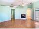 Light-filled living room with a fireplace, hardwood floors, and access to the bathroom at 13542 Norman Cir, Hudson, FL 34669