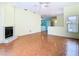 Spacious living room with fireplace, ceiling fan, and parquet floors opens to kitchen at 13542 Norman Cir, Hudson, FL 34669