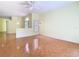 Bright living room features wood floors, decorative chandeliers and a ceiling fan at 13542 Norman Cir, Hudson, FL 34669