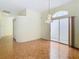 Bright living space features parquet floors, sliding doors, and elegant chandelier lighting at 13542 Norman Cir, Hudson, FL 34669